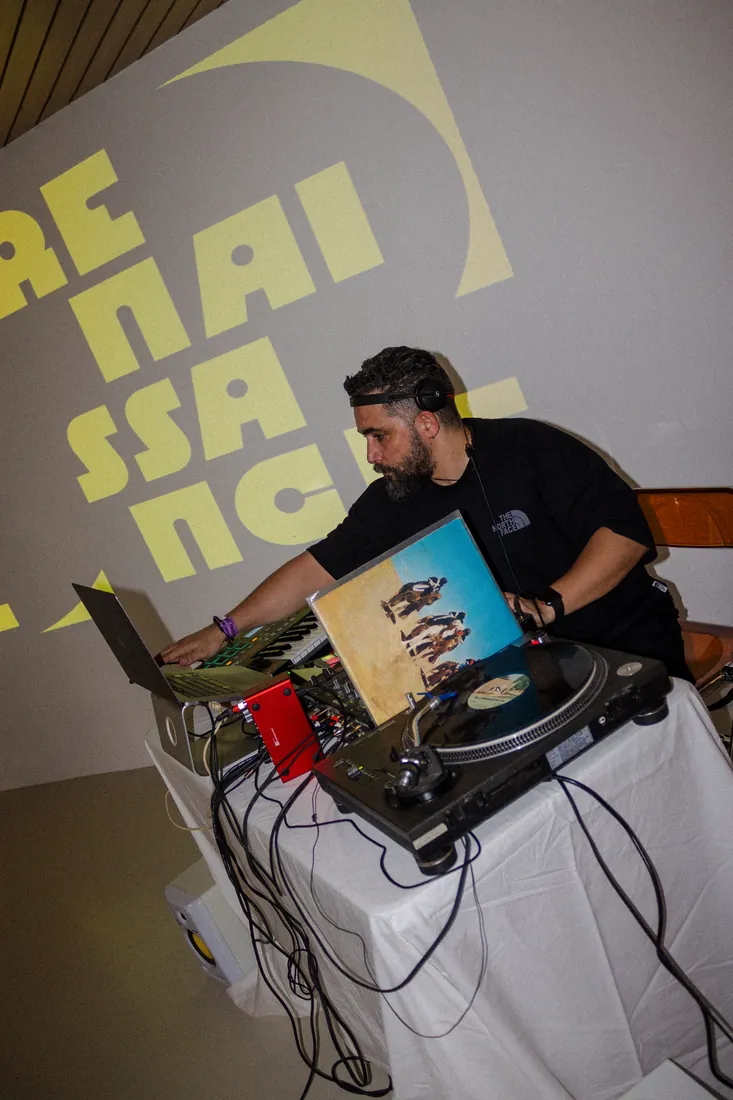 Semir Lajmi playing vinyl in front of a Renaissance wall