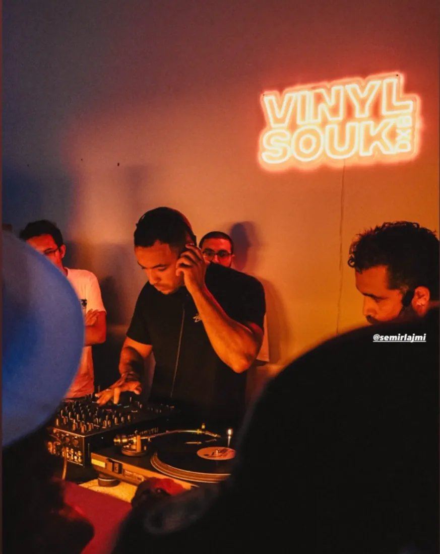 Semir Lajmi at the decks under a Vinyl Souk neon sign
