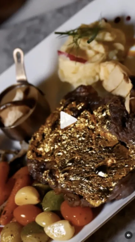 Vertical reel still of a gold-leaf steak